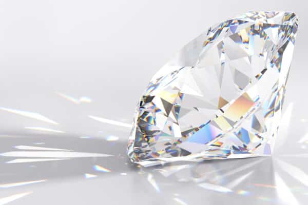 Sparkling round cut diamond on ligt gray background
